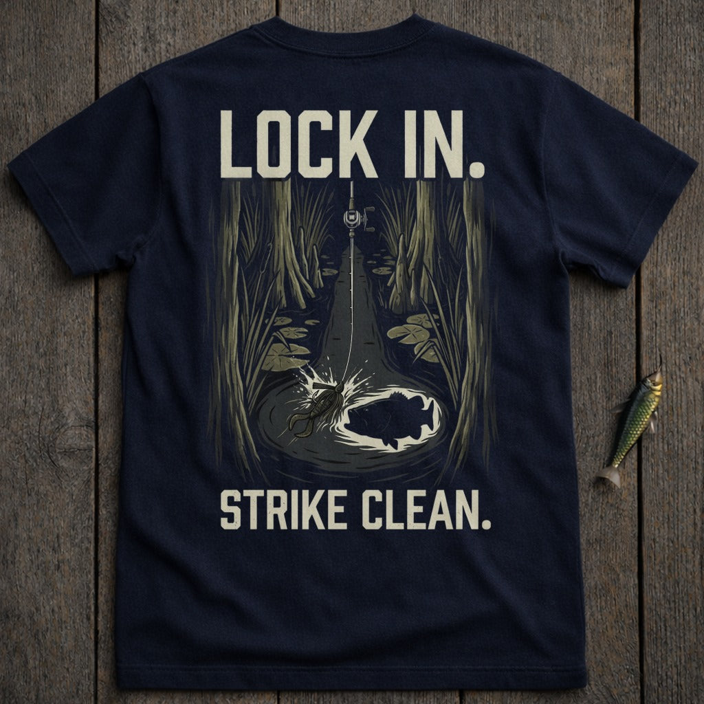 Dark t-shirt with text "LOCK IN. STRIKE CLEAN." and fishing illustration.