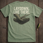 Green t-shirt with "LAYDOWN. LIVE THERE." text and submerged log graphic.