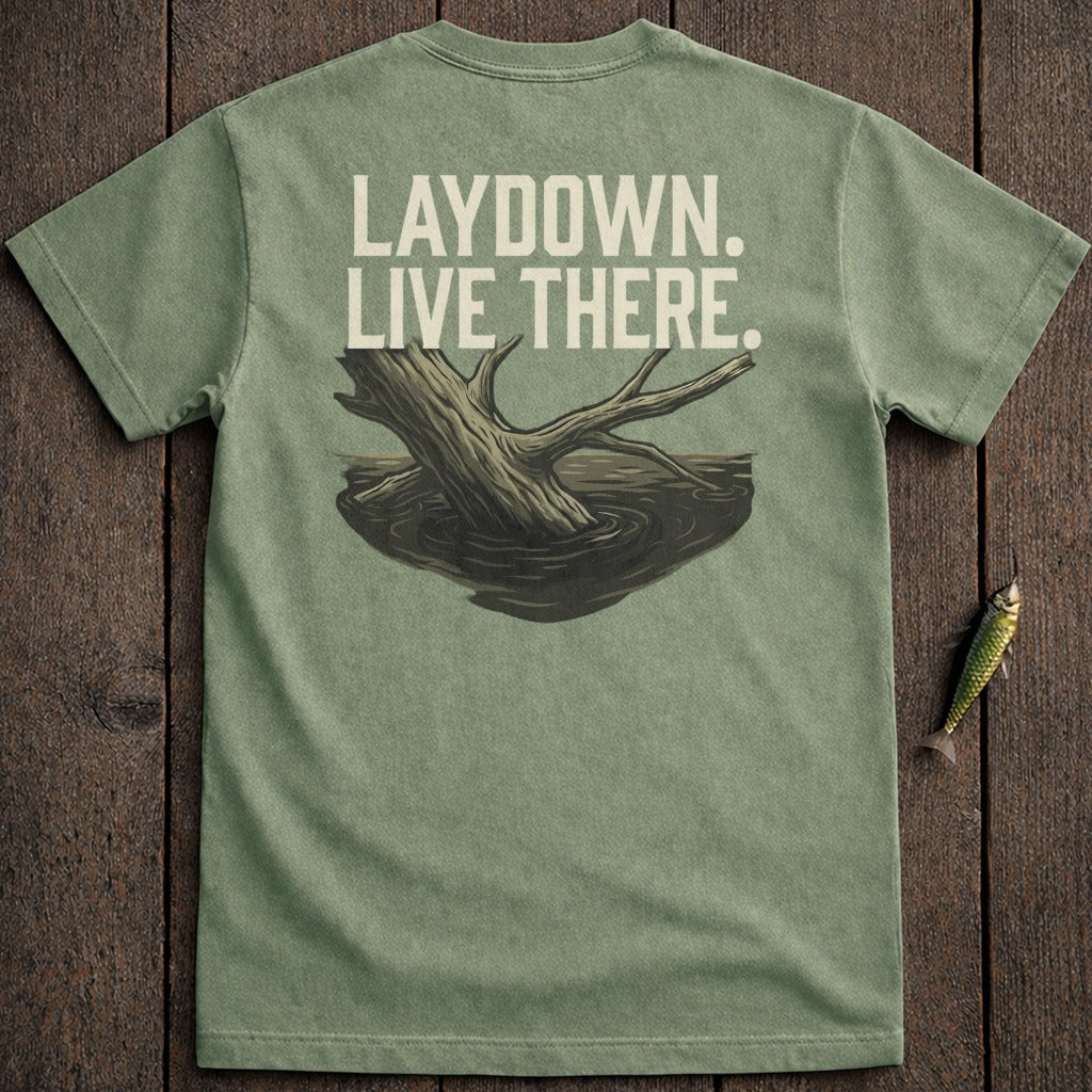 Green t-shirt with "LAYDOWN. LIVE THERE." text and submerged log graphic.