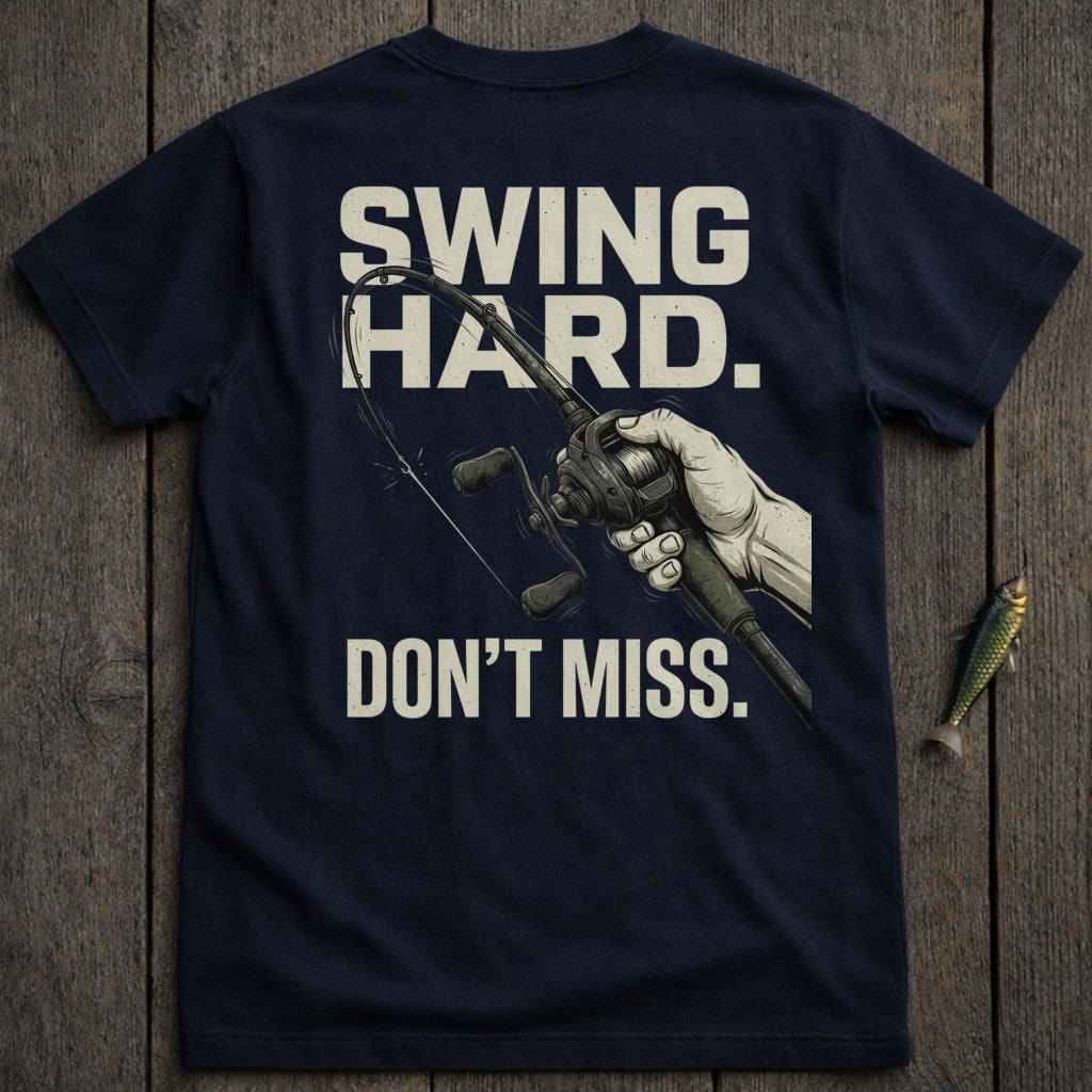 Navy t-shirt with "Swing Hard. Don't Miss." and fishing reel graphic.