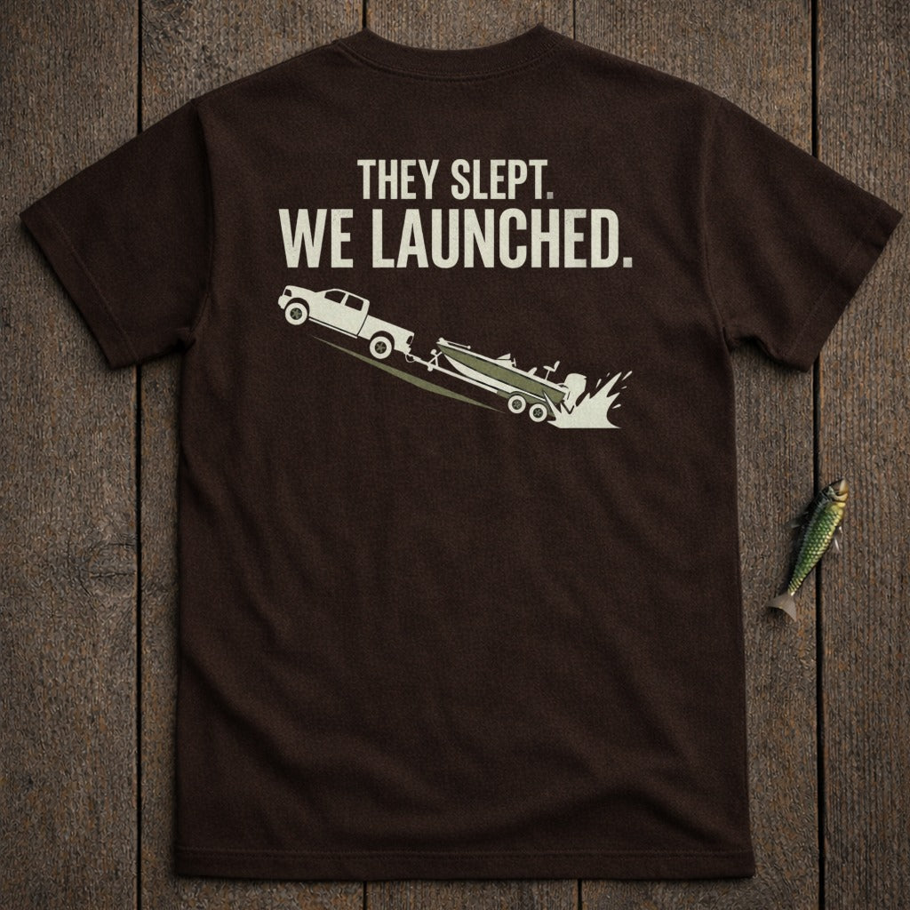 Brown t-shirt with white text and graphic of truck launching boat.