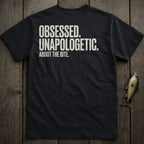 Black t-shirt with white text "OBSESSED. UNAPOLOGETIC. ABOUT THE BITE."