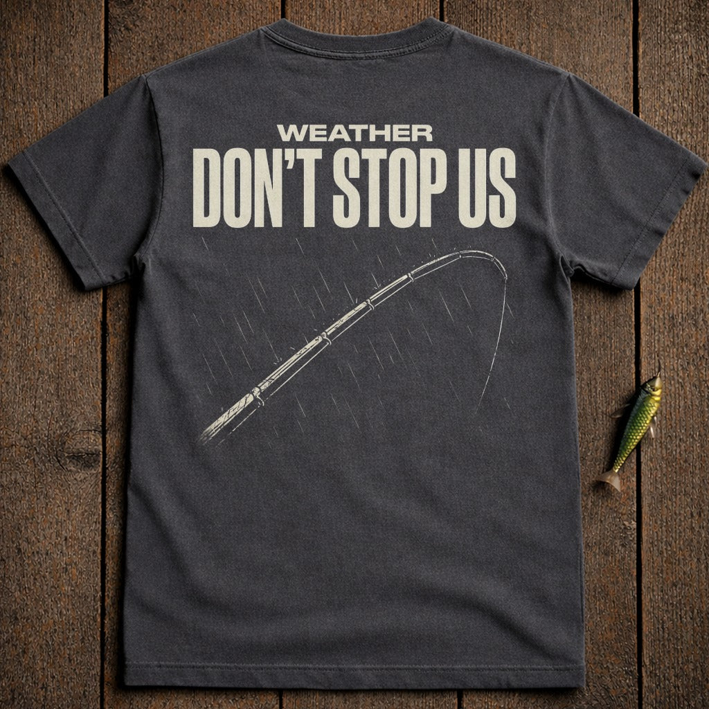 Dark gray t-shirt with "WEATHER DON'T STOP US" and fishing rod in rain.