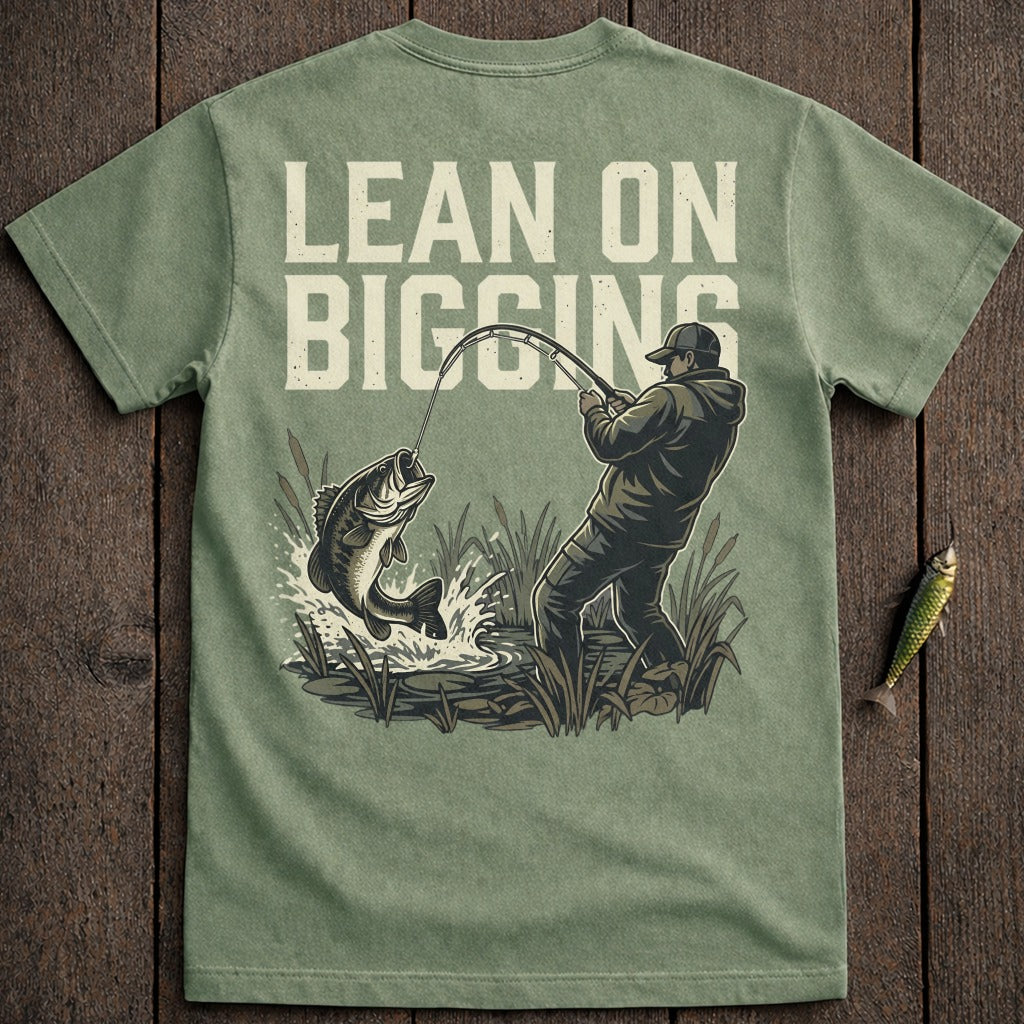 Fisherman reeling in a large bass, text "LEAN ON BIGGINS".