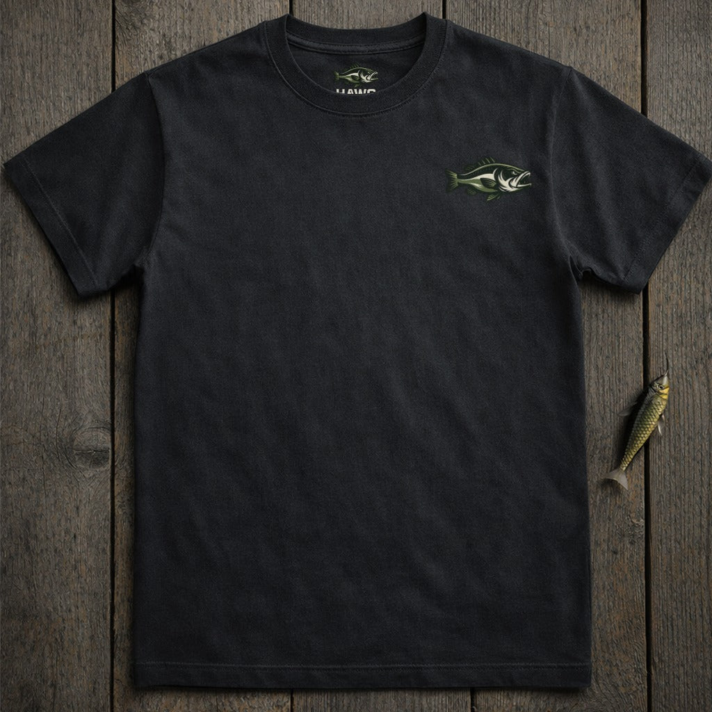 Black t-shirt with green fish logo on chest, laid flat on wood.