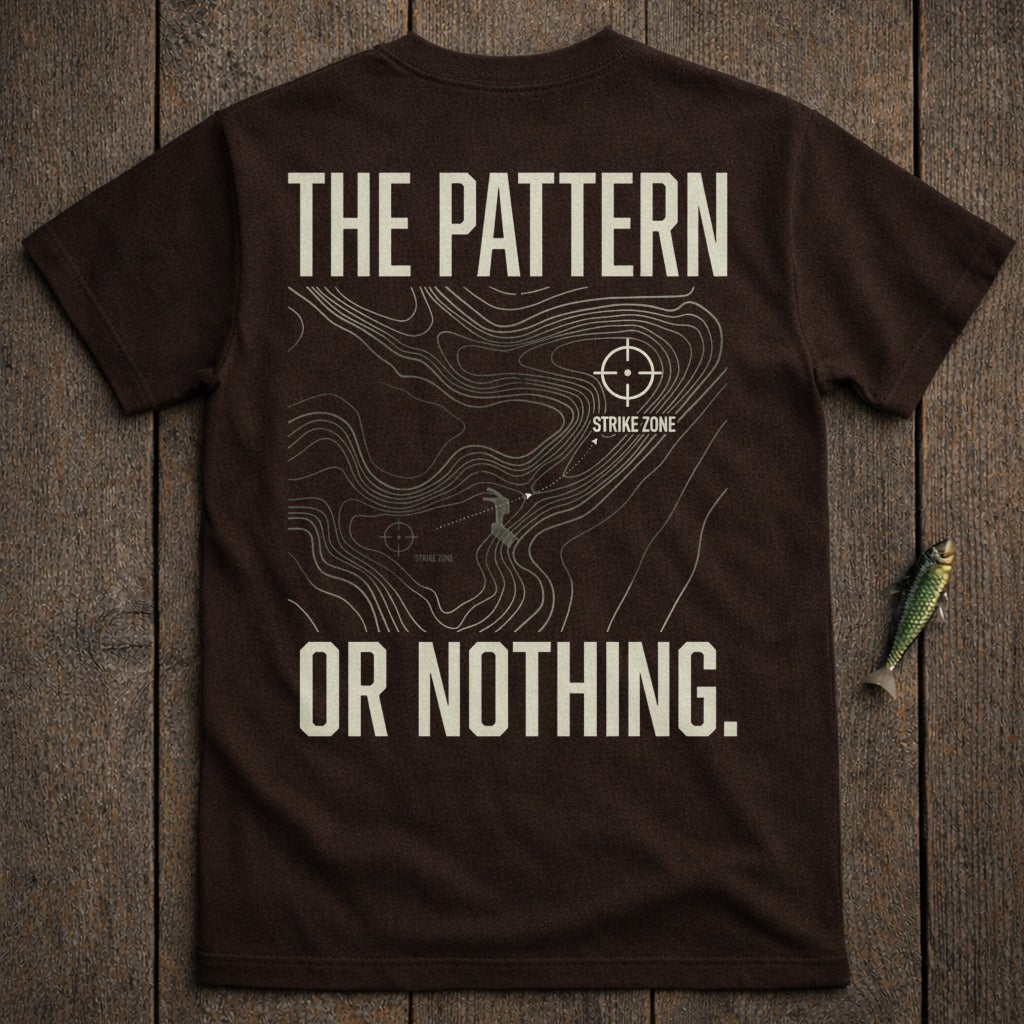 Brown t-shirt with "THE PATTERN OR NOTHING." text and topographic map design.
