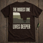 Brown t-shirt with "THE BIGGEST ONE LIVES DEEPER" text and geological layers illustration.