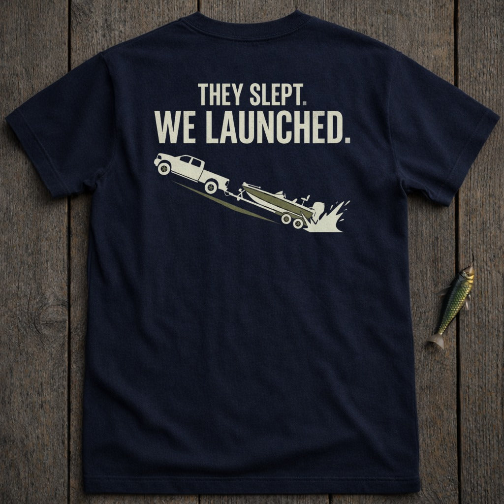 Navy t-shirt with truck launching boat graphic and text "THEY SLEPT. WE LAUNCHED."