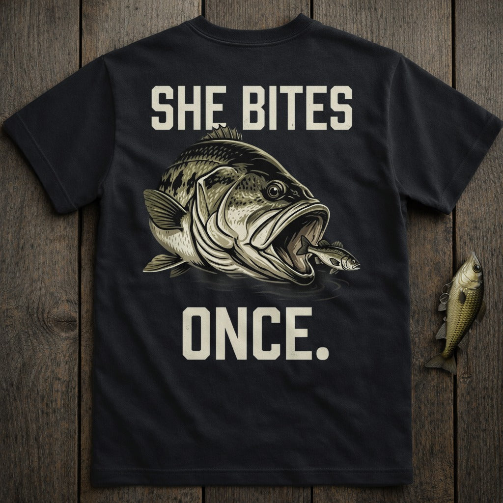 Black t-shirt with "SHE BITES ONCE." and a graphic of a bass eating a smaller fish.