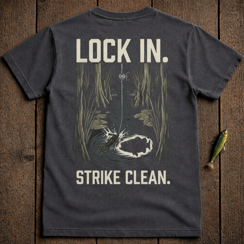 T-shirt graphic with fishing lure, fish splashing, and text "LOCK IN. STRIKE CLEAN."