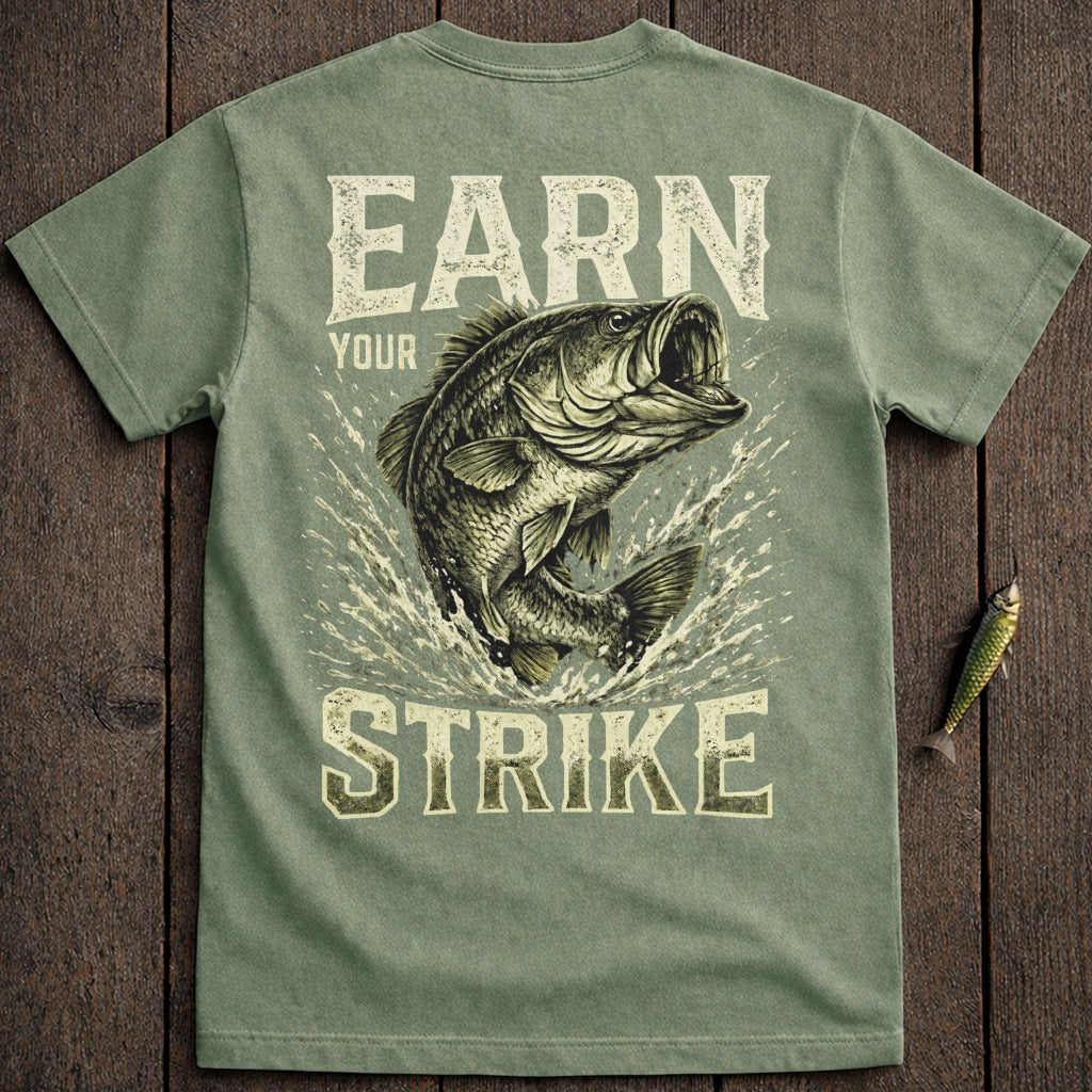 Bass fish jumping from water on green t-shirt with text "EARN YOUR STRIKE".
