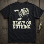 Black t-shirt with fishing reel graphic and text "HEAVY OR NOTHING".