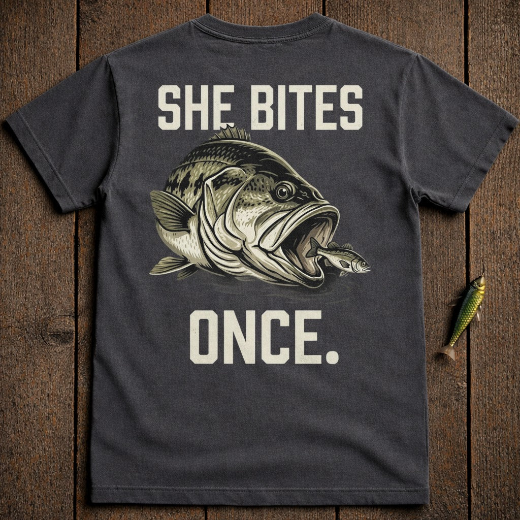 Dark t-shirt with a large bass eating a smaller fish and text "SHE BITES ONCE."