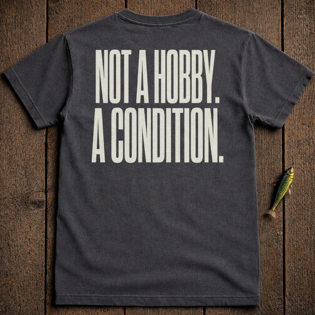 Dark gray t-shirt with "NOT A HOBBY. A CONDITION." text in cream.