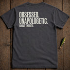 Dark grey t-shirt with white text "OBSESSED. UNAPOLOGETIC. ABOUT THE BITE."