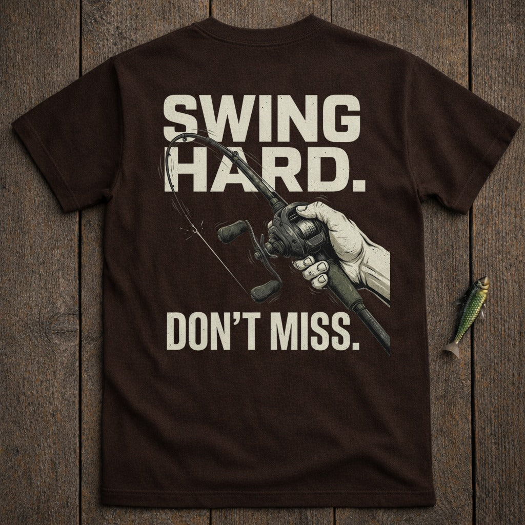 Brown t-shirt with "Swing Hard. Don't Miss." text and fishing rod.
