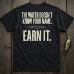 Black t-shirt with text "THE WATER DOESN'T KNOW YOUR NAME. EARN IT."