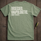 Olive green t-shirt with white text "Obsessed. Unapologetic. About the Bite."