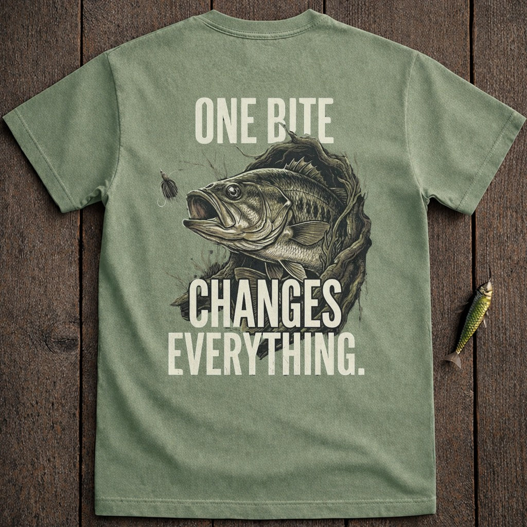 Green t-shirt with a bass breaking out of wood, text "ONE BITE CHANGES EVERYTHING."
