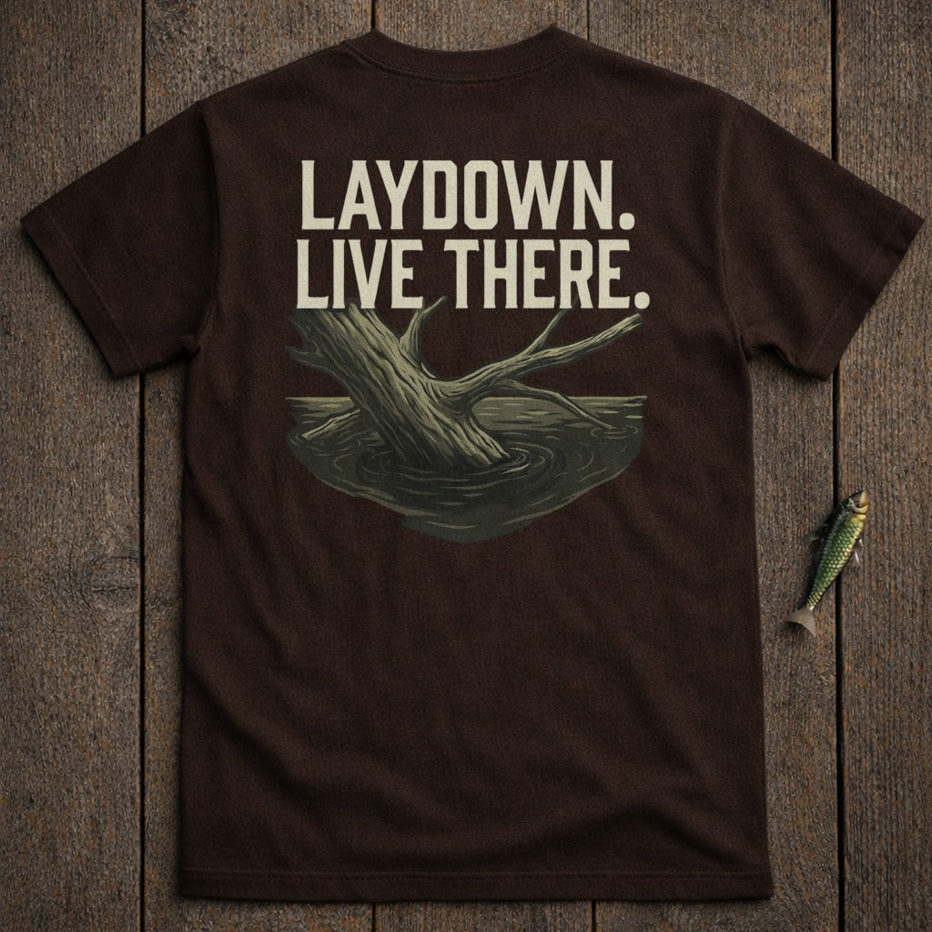Brown t-shirt with "LAYDOWN. LIVE THERE." text and a submerged tree branch graphic.
