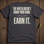 Dark t-shirt with "The water doesn't know your name. Earn it." text.
