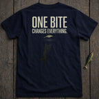 Navy t-shirt with "ONE BITE CHANGES EVERYTHING." and a jumping fish graphic.